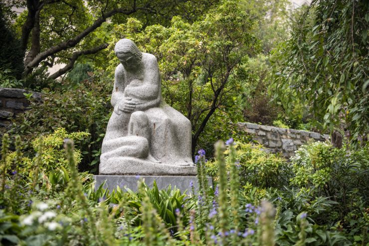 Stone statue and lush vegetation in the Cathedral's gardens