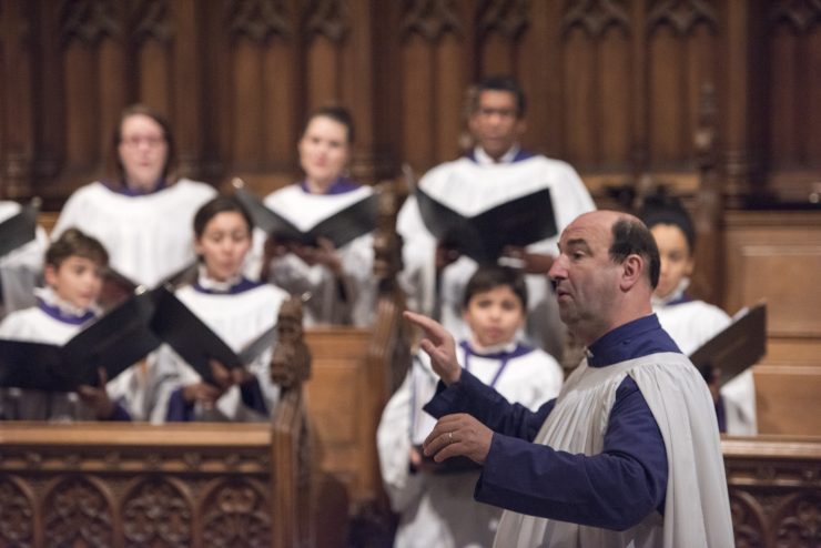 Conductor directing choir in Cathedral's Great Choir