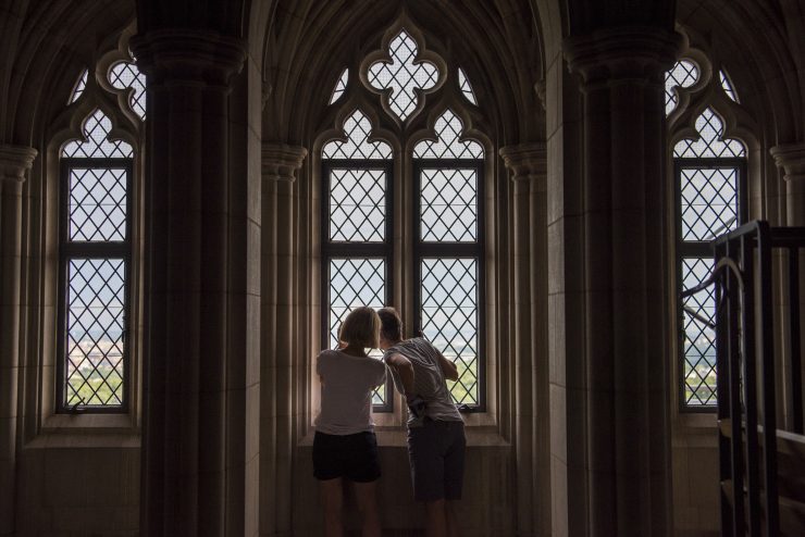 Visitors looking out a window during a sightseeing tour