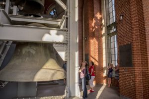 Visitors looking up and taking pictures in the Cathedral tower during a sightseeing tour